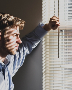 Man looking out of window
