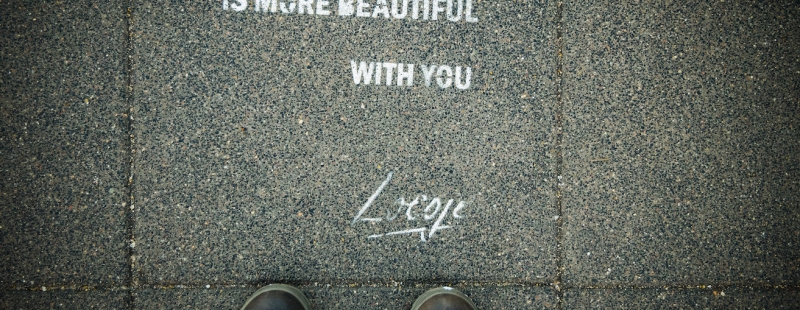 Feet with the world is more beautiful with text on ground